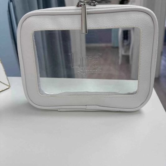 A white faux-leather cosmetic bag with a clear front window showing the brand name 'Lura' printed inside, resting on a white surface.