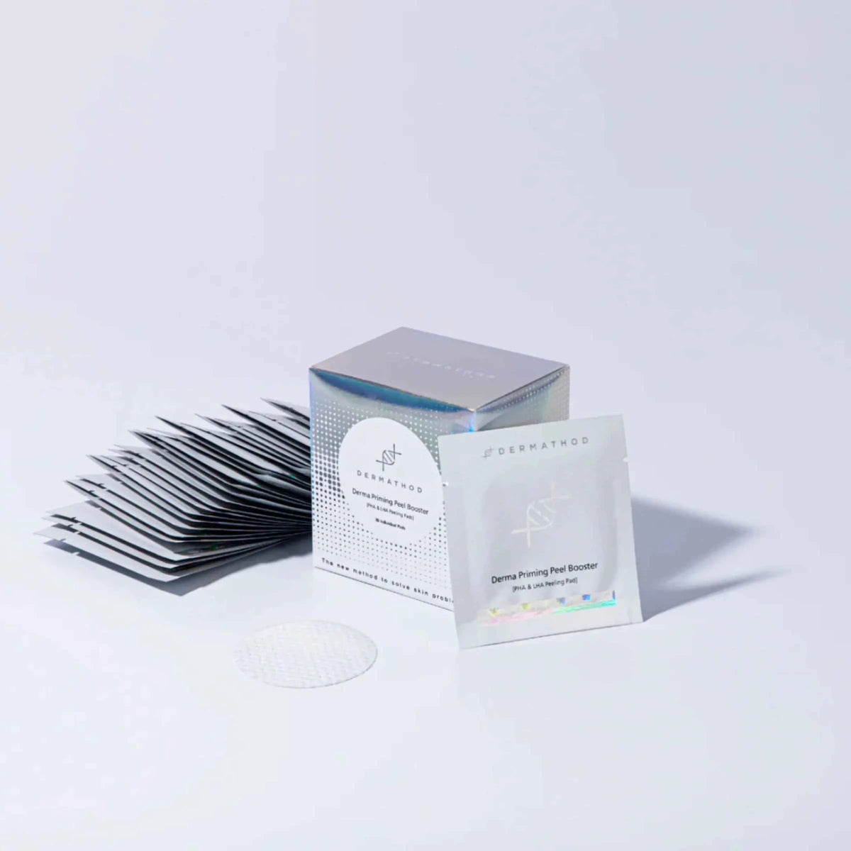 Eyelash extensions and a box with a DERMATHOD brand label on a white background