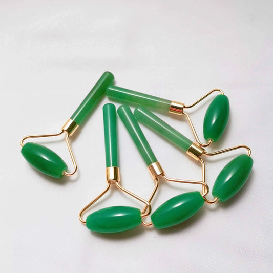 Five green jade roller tools with gold metal wire handles, arranged on a plain white background.