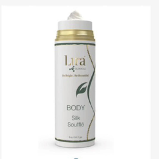 A white cylindrical pump bottle of Lira Naturals Body Silk Soufflé, featuring a white cap with a gold band and a green leaf graphic on the label.