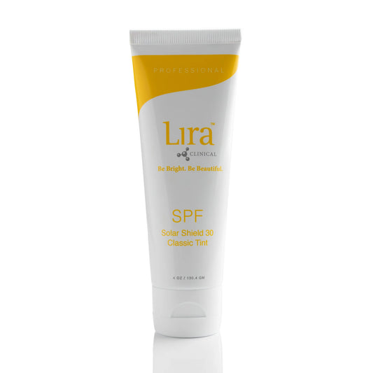 A white squeeze tube of Lira Clinical SPF 30 Sun Block with a yellow accent band and yellow text, standing upright on a white reflective surface.