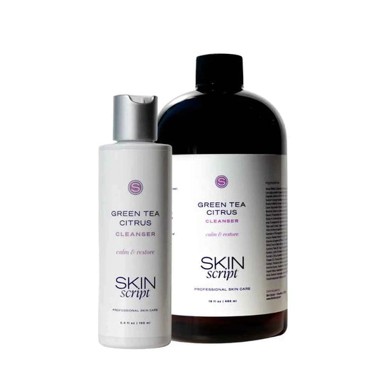 Two SKIN script professional skin care bottles on a white background: a smaller white bottle of Green Tea Citrus Cleanser with a silver cap, and a larger dark amber bottle of the same cleanser with a black cap.