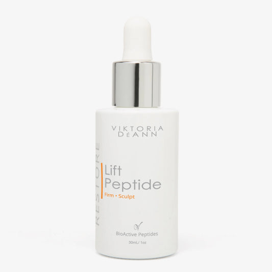 Viktoria Deann Lift Peptide serum in a white bottle with a silver dropper cap, on a light gray background.