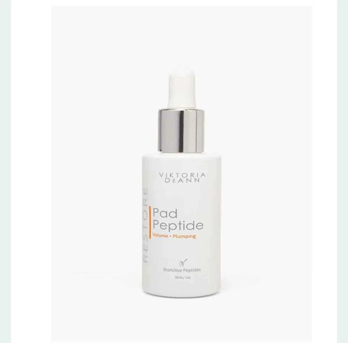 A white bottle of Victoria Deann Restore Pad Peptide with a silver pump dispenser and white dropper cap, set against a plain white background.