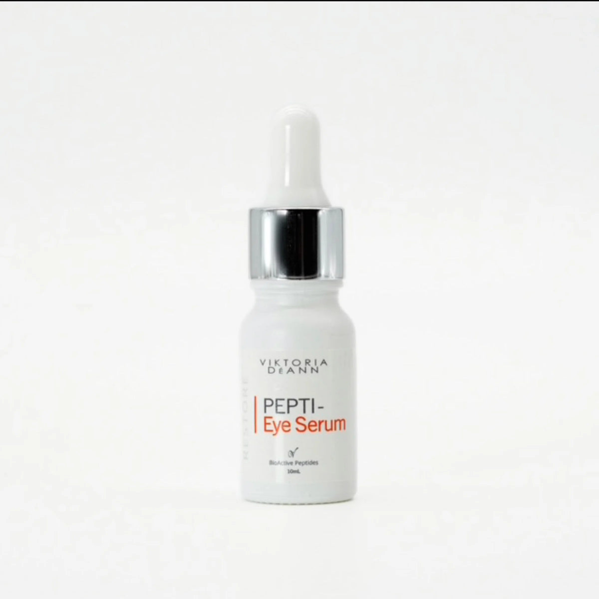 A 20ml dropper bottle of Victoria Dyann Pepti-Eye Serum, featuring a white bottle, a shiny silver collar, and a white dropper cap, set against a plain white background.